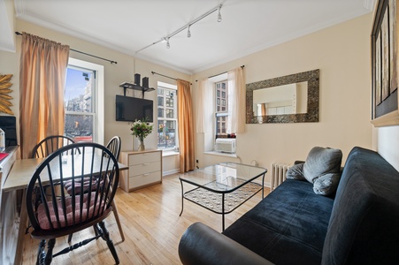 Your bright city retreat features comfy seating, natural light, and stylish décor for the perfect urban getaway.