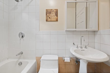 Refresh in your clean, well-appointed bathroom with modern fixtures and soothing neutral tones.