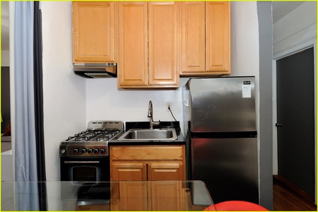 Your fully equipped kitchen features stainless steel appliances and warm wood cabinetry, perfect for preparing meals during your stay.