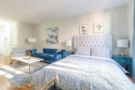 Sink into your plush tufted bed with premium linens while enjoying the cozy seating area—perfect for morning coffee or unwinding after exploring.