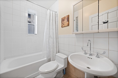 Your private bathroom features a relaxing tub-shower combo, perfect for unwinding after exploring the city.