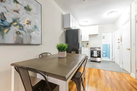 Your stylish kitchen awaits with modern appliances and a welcoming dining table where you can savor morning coffee or evening meals together.