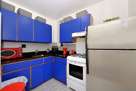 Your bright kitchen features bold blue cabinets, modern appliances, and everything needed for home-cooked meals during your stay.