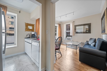 Step into your bright, open living space where warm hardwood floors and thoughtful touches create the perfect home base for your city adventure.