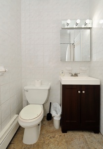 Your private bathroom features modern fixtures with a sleek vanity, mirror with lighting, and fresh white tiles throughout.