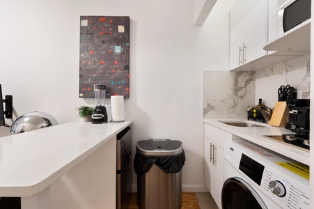 Your modern kitchen comes equipped with everything you need, including a washer for convenient laundry during your stay.