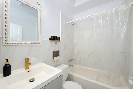 Step into your spa-like bathroom with marble-inspired walls, gleaming fixtures, and thoughtful amenities for your comfort.