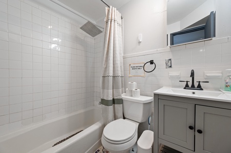 Step into your pristine bathroom featuring a relaxing soaking tub, modern vanity, and crisp white subway tiles that create a spa-like retreat.