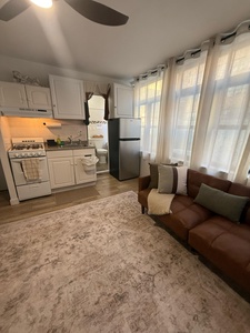 Unwind in your cozy open-plan space where the fully equipped kitchen meets comfortable seating—perfect for cooking and relaxing together.