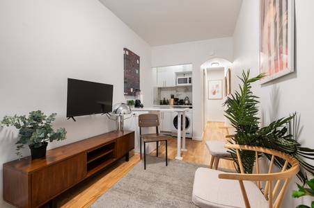 Relax in your stylish living space with warm wood floors, modern furnishings, and a fully equipped kitchen just steps away.