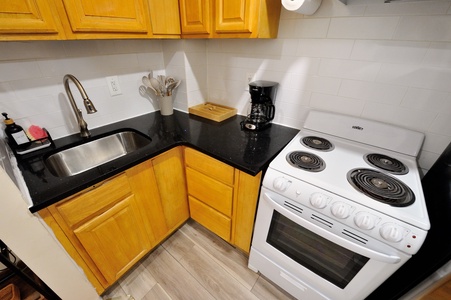 Your fully equipped kitchen awaits with granite counters, stainless sink, and everything needed to prepare your favorite meals.