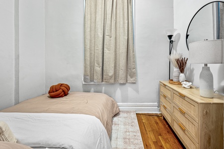 Your cozy bedroom features natural textures and warm wood tones, creating a peaceful retreat with thoughtful styling touches.