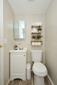 Your private bathroom features thoughtful touches with fluffy towels and fresh greenery, creating a clean, spa-like retreat.