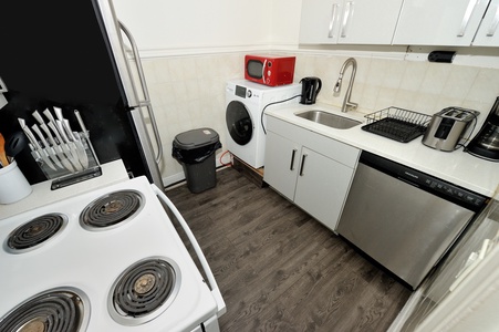 Your fully-equipped kitchen awaits with modern appliances, washer/dryer, and everything you need for comfortable cooking.