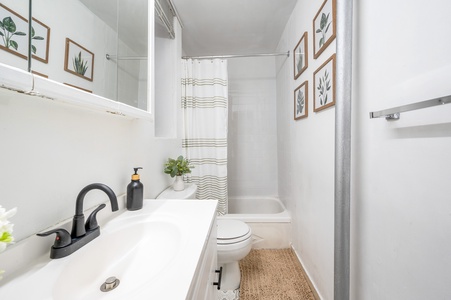 Your private bathroom features fresh botanical artwork and modern amenities for a refreshing start to each day.