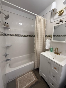 Step into your refreshing bathroom with a luxurious soaking tub, elegant mosaic tile accents, and thoughtfully placed amenities for your comfort.