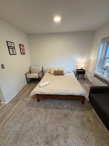 Sink into your comfortable bed with fresh linens, and relax in the modern chair with natural light streaming through your window.