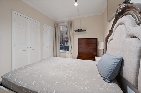 Sink into the plush headboard and soft linens as city views fill your window, creating your perfect urban retreat.