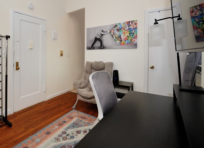 Your creative workspace awaits with contemporary art, ergonomic seating, and warm hardwood floors for inspired productivity.