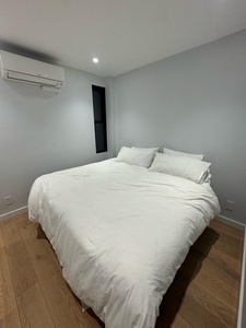 Your comfortable bedroom awaits with crisp linens, climate control, and peaceful gray walls for restful nights.