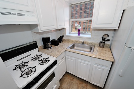 Cook memorable meals in this fully-equipped kitchen with granite counters, gas range, and city views from your window.