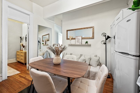 Your stylish dining space invites memorable meals with warm wood tones, comfortable seating, and thoughtful decor creating the perfect gathering spot.