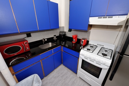 Your fully equipped kitchen features bold blue cabinets, modern appliances, and everything you need to prepare delicious meals during your stay.