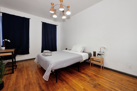 Step into your serene retreat with crisp white linens, warm hardwood floors, and modern touches that create the perfect peaceful sanctuary.