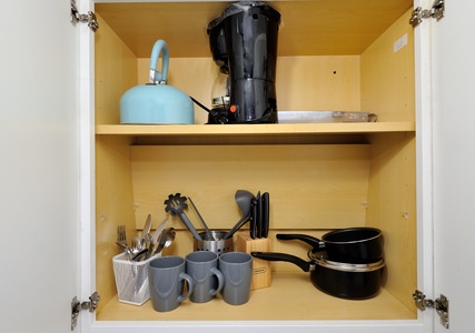 Your fully stocked kitchen cabinet features everything you need for home-cooked meals, from coffee maker to cookware and utensils.