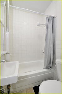 Refresh in your clean bathroom with a deep soaking tub and crisp white tiles.