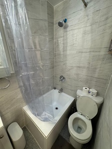 Your private bathroom features marble-look tiles and a tub-shower combo for relaxing soaks or quick rinses after exploring the city.