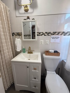 Step into your sparkling clean bathroom with elegant brass fixtures, fresh towels, and thoughtful amenities waiting for you.