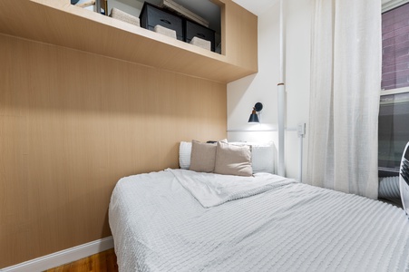 Your cozy bedroom features a comfortable bed with soft linens, built-in storage, and gentle reading light for peaceful nights.