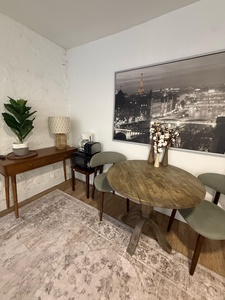 Settle in for your morning coffee at this charming dining nook, where Parisian elegance meets cozy comfort in your home away from home.