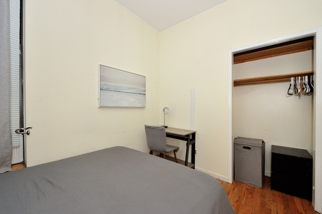 Your cozy bedroom features a comfortable workspace and organized closet storage for a productive, relaxing stay.