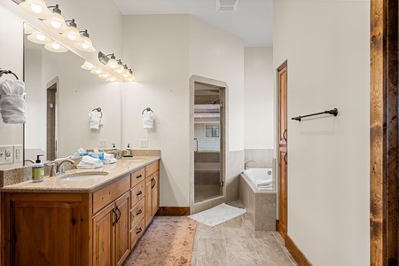 Your private sanctuary features dual sinks and elegant granite counters, perfect for refreshing after a day of adventure.