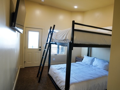 Your cozy bunk room offers comfortable sleeping with crisp white linens and private access to your own outdoor space.