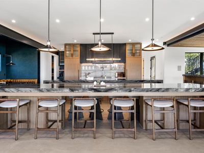 Gather around this stunning marble-topped island where your group can cook, dine, and connect together. Modern pendant lighting sets the mood for memorable shared meals.