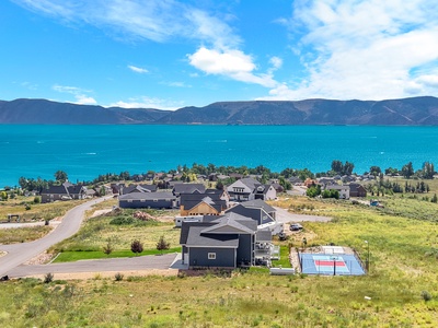 Stunning lakeside community with turquoise waters and mountain backdrop offers peaceful residential setting near recreational facilities.