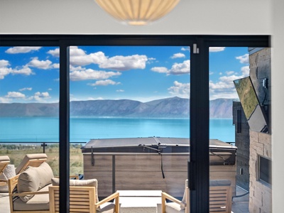 You'll wake to stunning lake and mountain vistas through expansive windows that frame nature's masterpiece. Your private balcony invites morning coffee with panoramic views of turquoise waters.