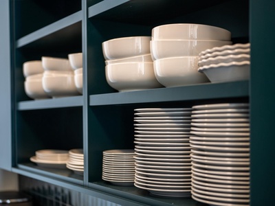 Well-stocked shelves with neatly arranged dishes, bowls, and linens make your kitchen feel complete and ready for any meal you choose to prepare.