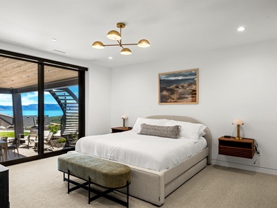 Wake up to stunning lake views from your comfortable bedroom, where modern elegance meets serene natural beauty just beyond your private terrace.