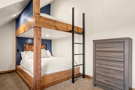 Rustic bunk beds with a modern touch make this bedroom perfect for families. The sturdy wood frame and cozy linens invite restful nights after your adventures.