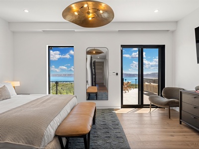 Wake up to sweeping lake and mountain views framing your bed. Step onto your private terrace for morning coffee in fresh mountain air. This bright, modern suite invites you to unwind in style.