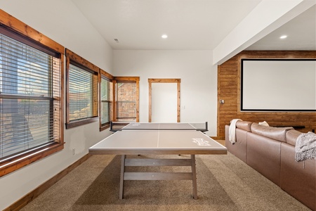 Challenge your travel companions to a friendly game of ping pong in this bright recreation space, where warm wood accents and comfortable seating create the perfect atmosphere for downtime between adventures.