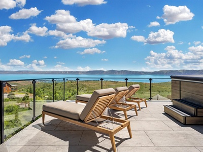 Soak in panoramic lake and mountain views from your private terrace, where loungers await beneath open skies and soft clouds. The perfect spot to unwind and breathe in the scenery.