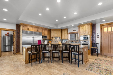 Averon Lodge - Bear Lake Luxury Rentals. Your gourmet kitchen features rich wood cabinetry, stainless appliances, and a spacious island where you can gather for meals and conversations.