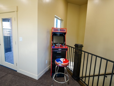 Challenge your friends to classic NBA Jam in your upstairs game corner, complete with authentic arcade stool for the ultimate retro gaming experience.