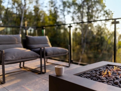 Picture yourself sipping morning coffee on your private terrace, surrounded by lush forest views and the warmth of a modern firepit. Pure relaxation awaits.