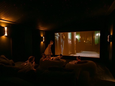 Gather for movie night in your private home theater, complete with plush seating and immersive screen—perfect for cozy family evenings under the stars.
